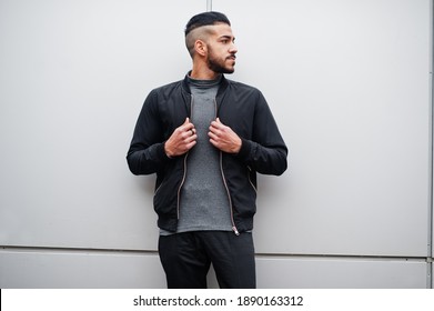 Portrait Of Stylish Arab Beard Man Wear Grey Turtleneck And Black Jaket. Arabian Model Guy Against Steel Wall.