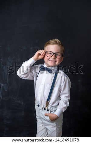 Portrait of stylish boy in suite. Child in glasses has idea. Little businessman. Success, bright idea, creative ideas and innovation technology concept. Back to school