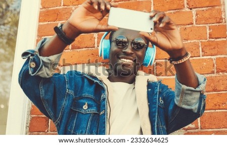 Similar – Young happy black man is listening to music