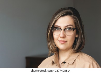 Portrait of stylish intellectual credible woman. Nice smile, glasses. The concept of a doctor, psychologist, psychiatrist, blogger, designer.