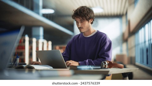 Portrait of a Stylish Male Student Working on His University Exercise on a Laptop Computer. Young Handsome Man Studying an Online College Course in an Empty Quiet Public Library - Powered by Shutterstock