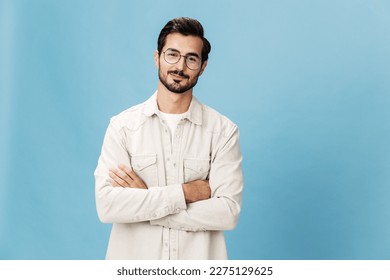 Portrait of a stylish man smile with teeth in glasses for farsightedness and myopia, on a blue background in a white T-shirt, fashionable clothing style, space space - Powered by Shutterstock