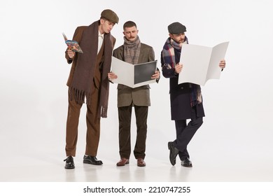 Portrait Of Stylish Men Reading Magazines And Newspapers Isolated Over Grey Background. Autumn Male Fashion. Concept Of Retro Fashion, Style, Friendship, Creativity, Youth Culture, Emotions, Ad