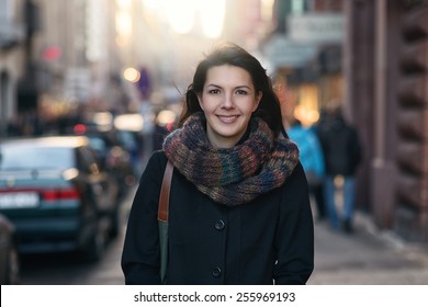 Portrait of a Stylish Pretty Young Woman in Autumn Fashion walking the city Looking at the Camera. - Shutterstock ID 255969193