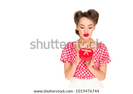 portrait of stylish woman in retro clothing with heart shaped gift isolated on white