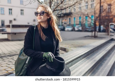 Portrait Of Stylish Woman Sitting On Stairs On Street Outdoors. Autumn Clothes, Accessories. Female Fashion.