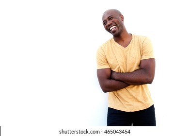 Portrait Of Stylish Young Black Guy Standing With Arms Crossed And Laughing Against White Background