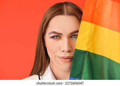 Portrait Of Stylish Young Transgender Woman With LGBT Flag On Color Background