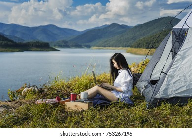 Portrait Of Succesful Woman With Laptop Near Camp Tent Outdoors