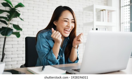 Portrait of success businesswoman enjoy success with laptop on work desk. Authentic shot joyful woman got jackpot, Surprised and celebrating her victory.
