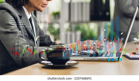 Portrait of success businesswoman using technology of laptop looking at progress of business financial investment data graph and chart business growth increase at office - Powered by Shutterstock