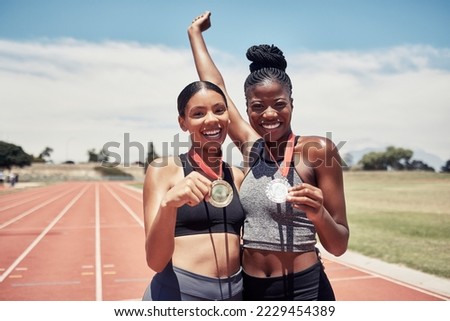 Portrait, success medals and women at stadium after winning running race or sports event outdoors. Fitness, winner and athlete friends happy with victory, goals or target achievement on track field.