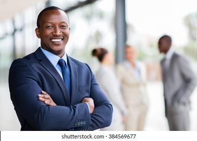 portrait of successful african office worker with arms crossed