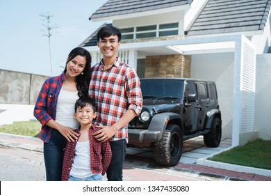 Portrait Of Successful Asian Family Having Their Own New Home And Car