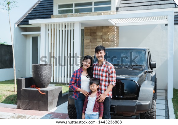 portrait of successful asian family having their own\
new home and car