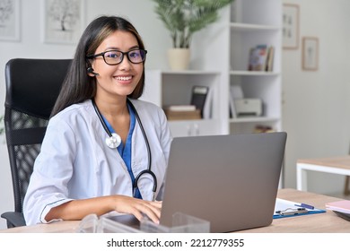 Portrait Of Successful Asian Young Female Doctor At Modern Workplace Using Laptop For Video Conference Chat With Patient During Virtual Consultation. Excellent Service, Online Visit To Therapist