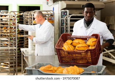 Portrait of successful baker during daily work in bakeshop. High quality photo