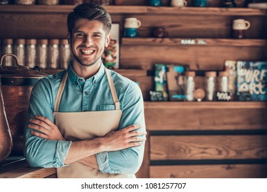 Portrait Of Successful Barista In Apron In Cafe. Young Entrepreneur In Coffee Shop.