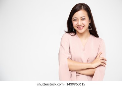 Portrait of successful business asian women in pink dress with arms crossed and smile isolated over white background, Young businesswoman smiling and looking at camera, Happy feeling concept