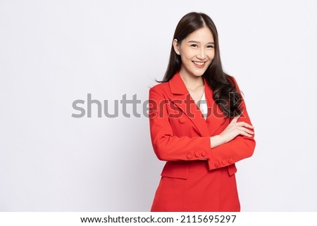 Portrait of successful business asian women in red suit with arms crossed and smile isolated over white background