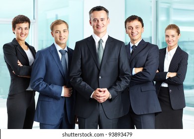 Portrait Of Successful Business Group Looking At Camera With Confident Man At Foreground