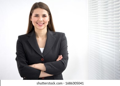 Portrait Of Successful Business Woman Against A Window.