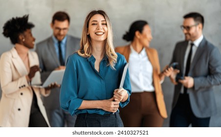 Portrait of successful business woman, entrepreneur while multiethnic colleagues working background. - Powered by Shutterstock