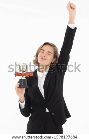 Portrait of successful business woman hoding trophy on white isolated background.