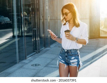 Portrait of a Successful Business woman Using iPhone 12 pro on city background