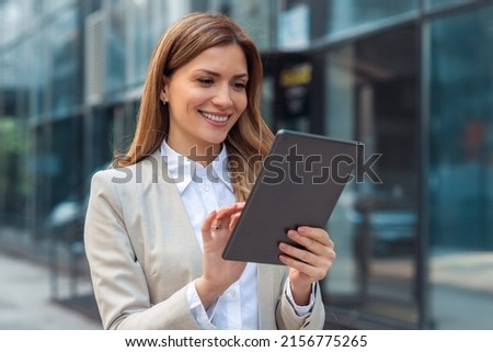 Portrait of a successful business woman using digital tablet