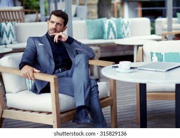 Portrait Of Successful Businessman In A Luxury Expensive Suit Resting At Cafe After Hard Work Day And Look Pensive,rich Entrepreneur Waiting For A Meeting With Colleague At Open Air Restaurant Terrace