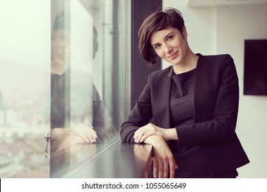 Portrait Of Successful Businesswoman By The Window Entrepreneur At Busy Startup Office