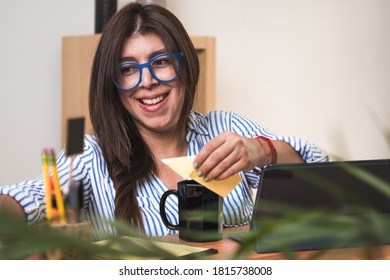 Portrait Of Successful Businesswoman Working At Office. Woman Leaving A Message At Adhesive Tape.