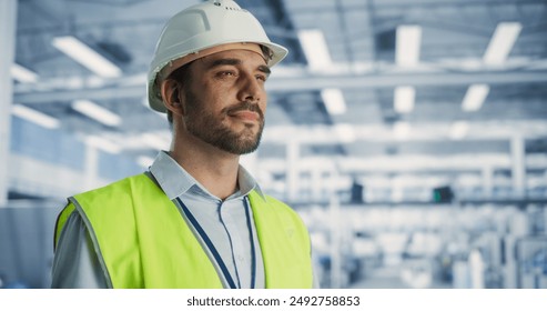 Portrait of Successful Caucasian Male Engineer Wearing a White Hard Hat at Electronics Manufacturing Factory. Heavy Industry Specialist Thinking About Advanced Technology Projects On Production. - Powered by Shutterstock