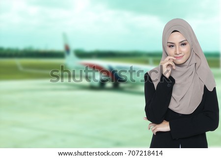 Portrait of Successful Confidence Muslim Business woman executive thinking posture over blur airplane landing airport background.
