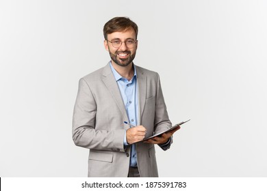 Portrait of successful and confident businessman in gray suit and glasses, writing something on clipboard and smiling, inspecting work environment - Powered by Shutterstock