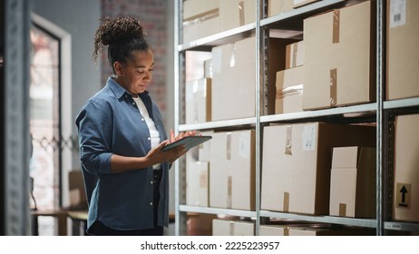 Portrait of a Successful Employee Checking Inventory, Writing in Tablet Computer. Black Woman Posing for Camera and Smiling in a Warehouse Storeroom with Orders Ready for Shipment. - Powered by Shutterstock