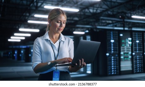 Portrait of Successful Female Chief Engineer or CEO Using Laptop Computer to Optimise Server Farm Cloud Computing Facility at the Evening Office. Cyber Security, Network Protection Concept - Powered by Shutterstock