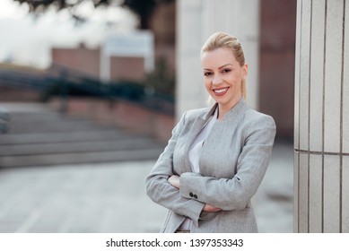 Portrait Of A Successful Female Leader Outdoors, Smiling At Camera.