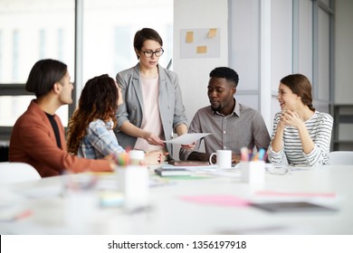 Portrait of successful female manager leading multi-ethnic team in meeting, copy space - Powered by Shutterstock