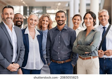 Portrait successful group business people at modern office looking at camera  Portrait happy businessmen   satisfied businesswomen standing as team  Multiethnic group people smiling 