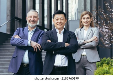 Portrait Of Successful And Happy Asian Boss With His Diverse Dream Team, Business People Outside Office Building Standing With Arms Crossed And Looking At Camera