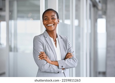 Portrait of successful mature black businesswoman standing in office with copy space. African american business woman in formal clothing standing in modern office: vision and future business company.