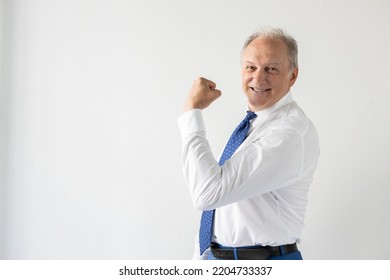 Portrait Of Successful Mature Businessman Showing Muscle. Senior Manager Wearing Shirt And Tie Looking At Camera And Smiling, Posing Against White Background. Success And Leadership Concept