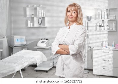 Portrait Of Successful Professional Doctor Cosmetologist Dermatologist Woman In Her Beauty Salon Smiling In White Medical Clothes Close-up