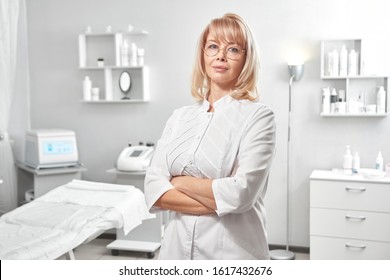 Portrait Of Successful Professional Doctor Cosmetologist Dermatologist Woman In Her Beauty Salon Smiling In White Medical Clothes Close-up