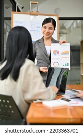 Portrait,  Successful And Professional Millennial Asian Female Boss Or CEO Lead The Meeting, Explaining And Coaching Something To Her Team.