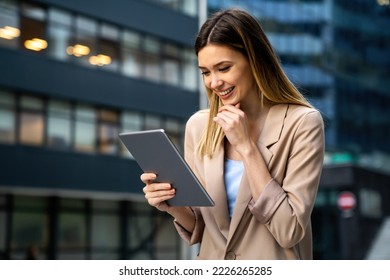 Portrait of successful woman using digital tablet in urban background. Business people concept - Powered by Shutterstock