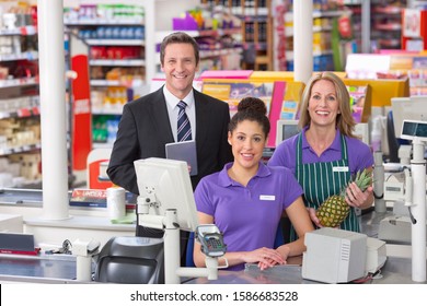 Portrait Of Supermarket Staff At Checkout