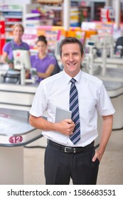 Portrait Of Supermarket Staff At Checkout